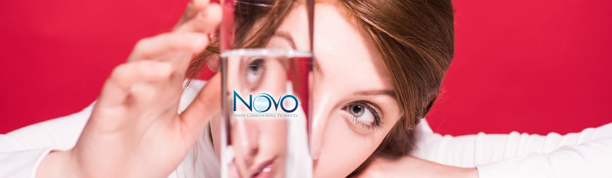 Picture showing woman looking at water that has been filtered by a Novo Water filter
