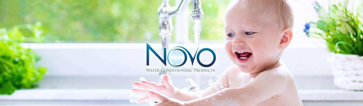 Picture of baby playing in water that has been treated by a Novo Water Softener